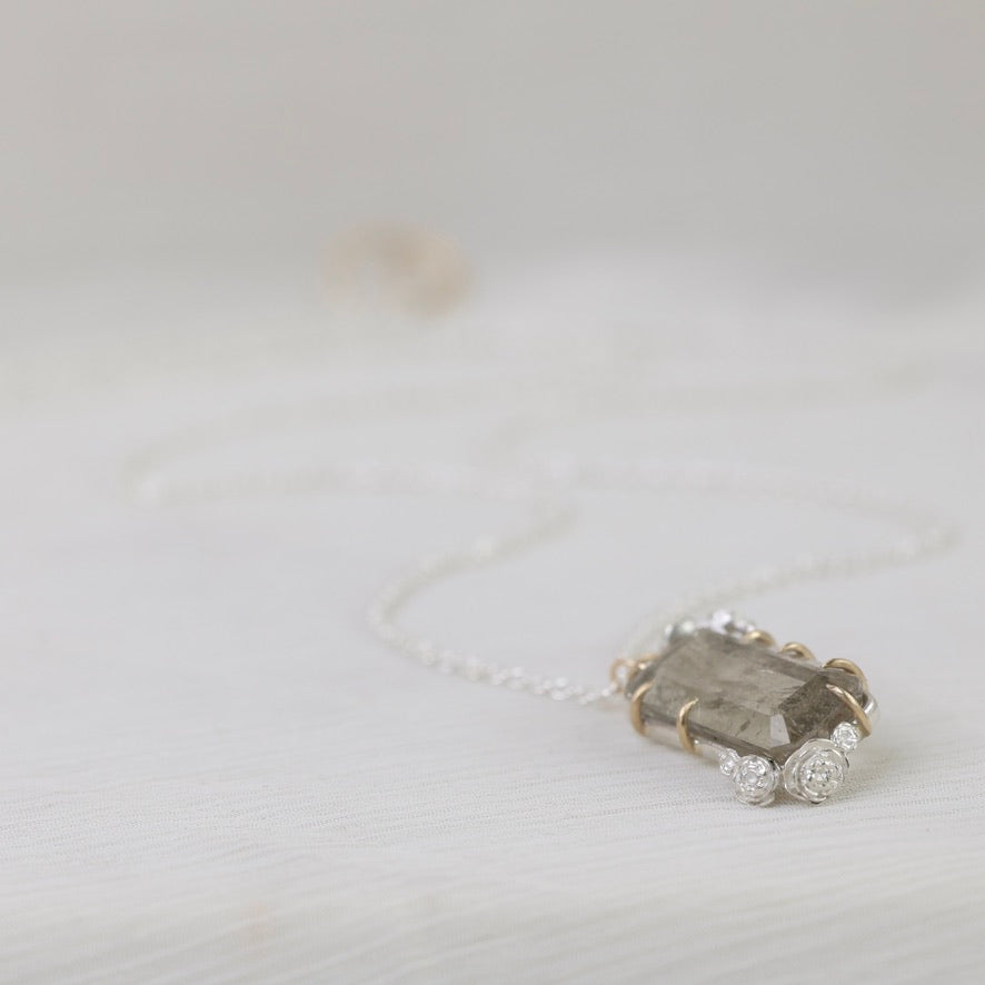 Necklace with a large stone pendant on a light gray background