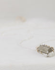 necklace with a grayish stone on a light background
