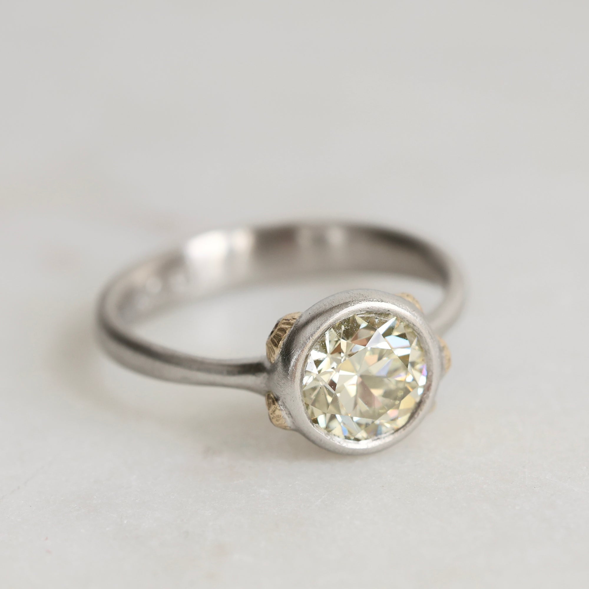 Platinum Ring with Gold Barnacles and a yellow diamond on a white background