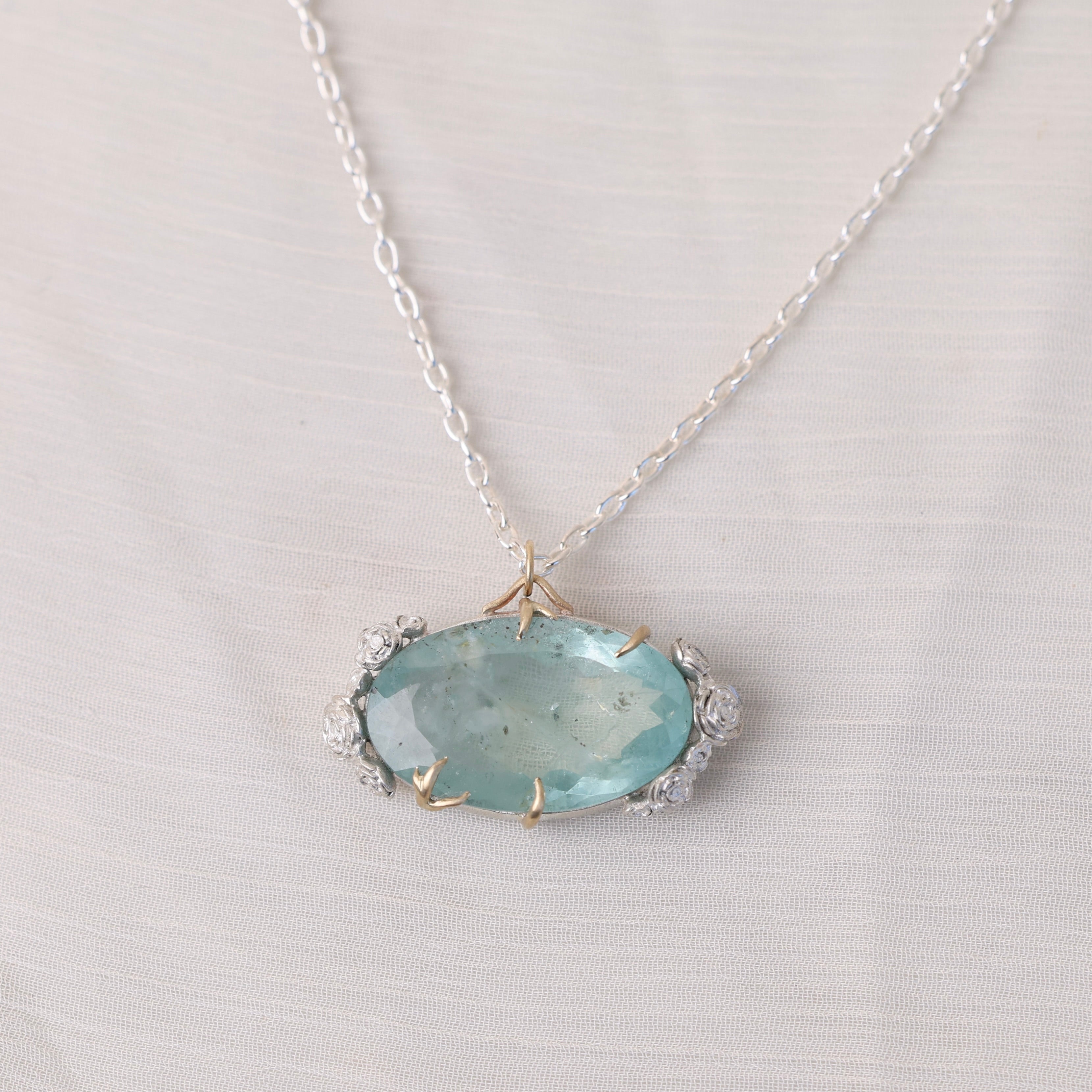 Necklace with a light blue pendant on a light gray background