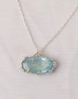 Necklace with a light blue pendant on a light gray background