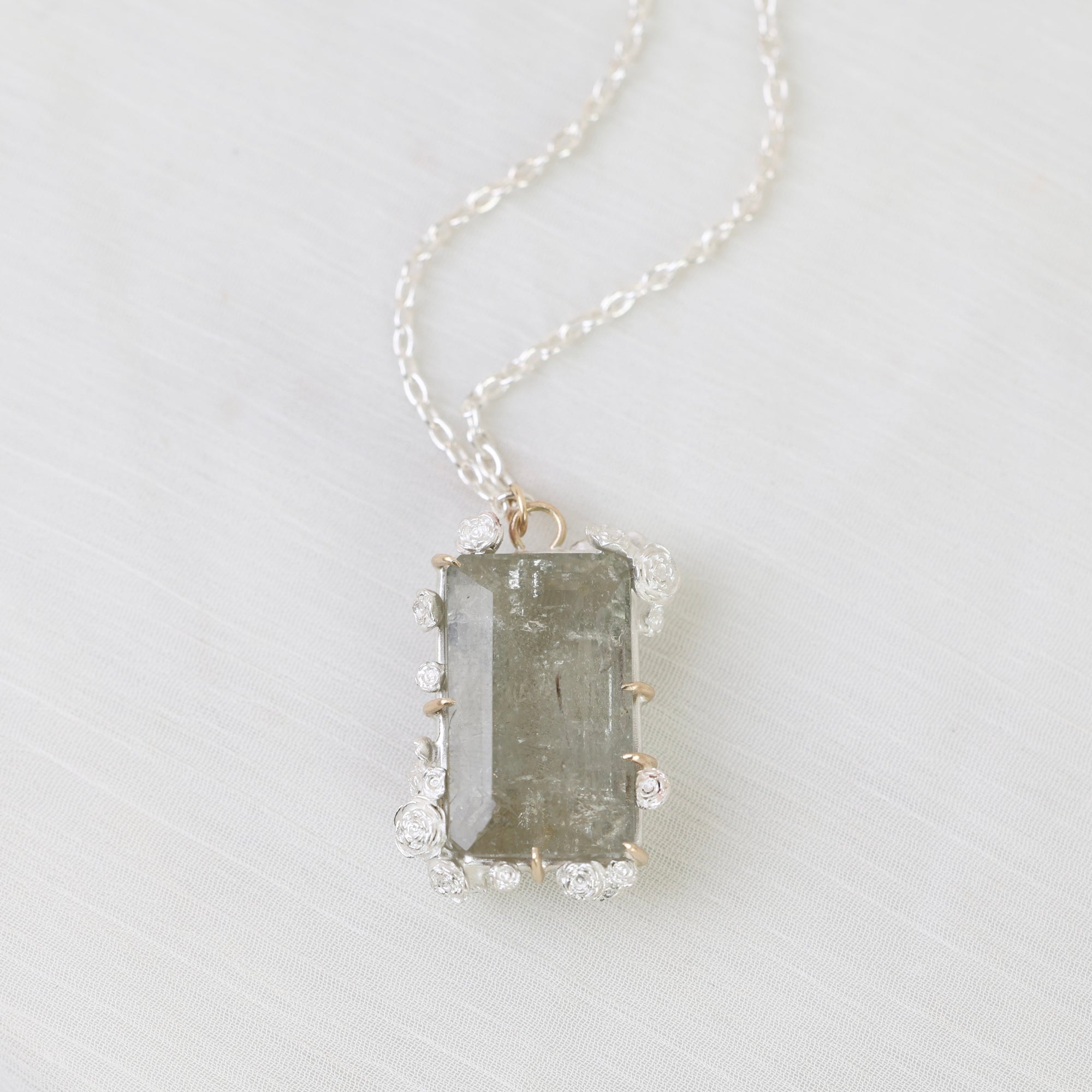 Necklace with a rectangular pendant on a light gray background