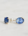 Pair of blue gemstone earrings on a light gray background