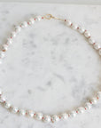 Pearl Strand with gold barnacles and red thread. 