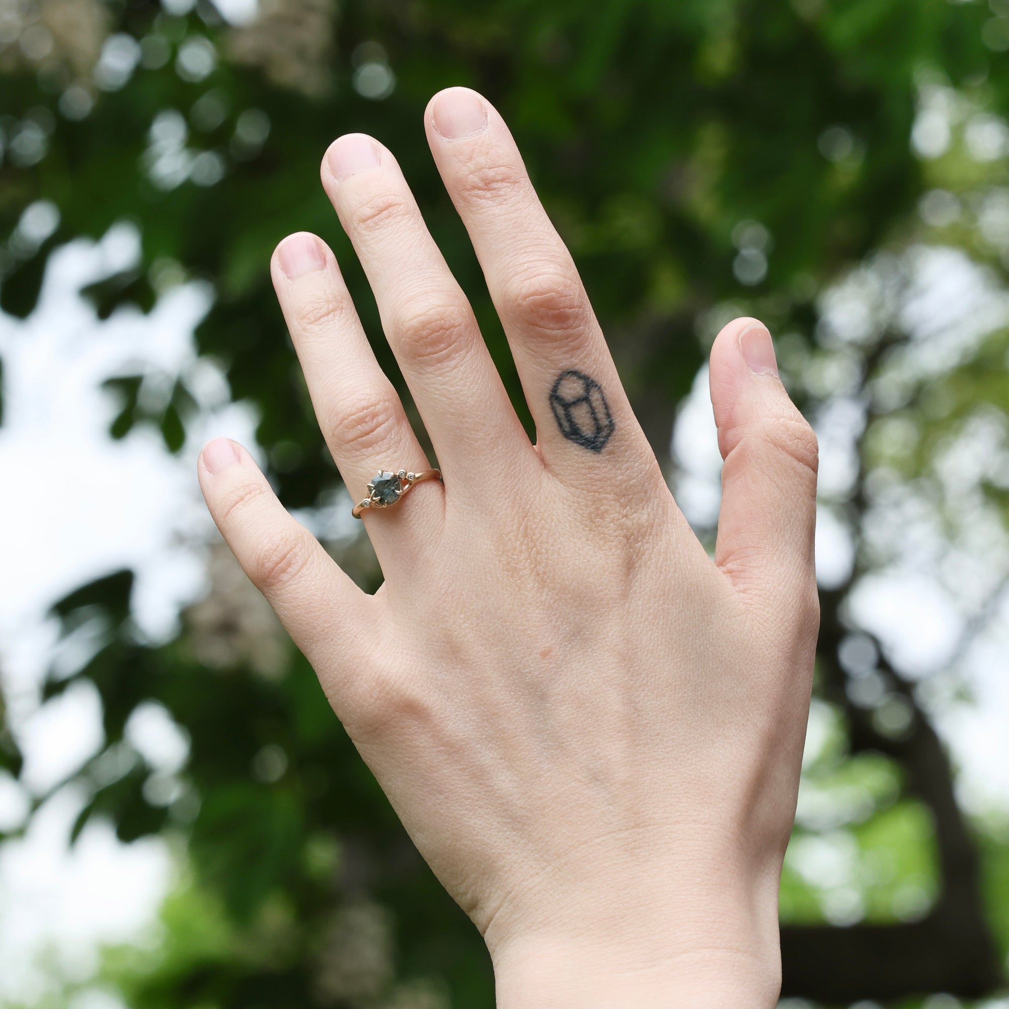 Gold branch ring on hand