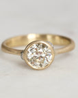 Gold ring with diamond and platinum barnacles on a white background 