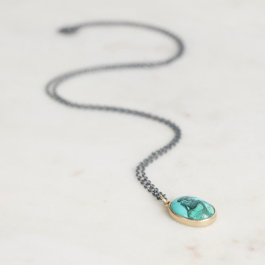 Necklace with a turquoise pendant on a light background