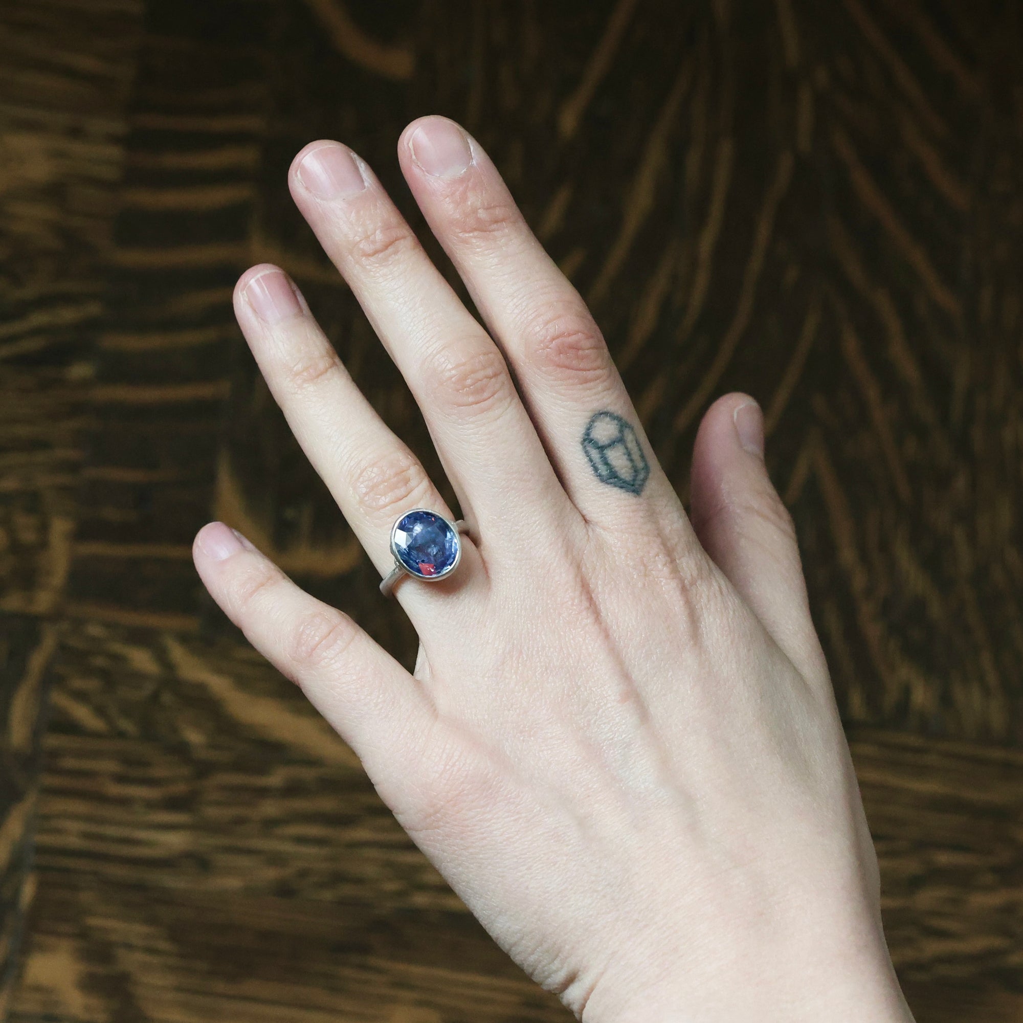 large blue stone ring on hand