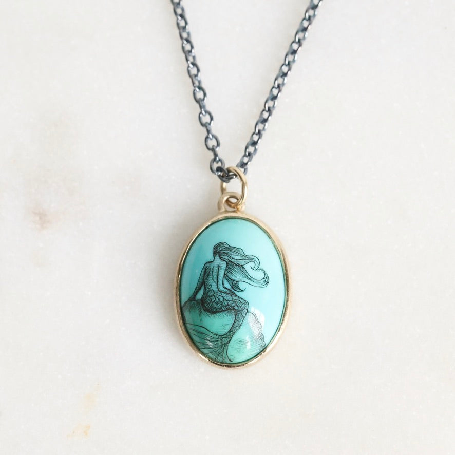 Necklace with a mermaid pendant on a light background