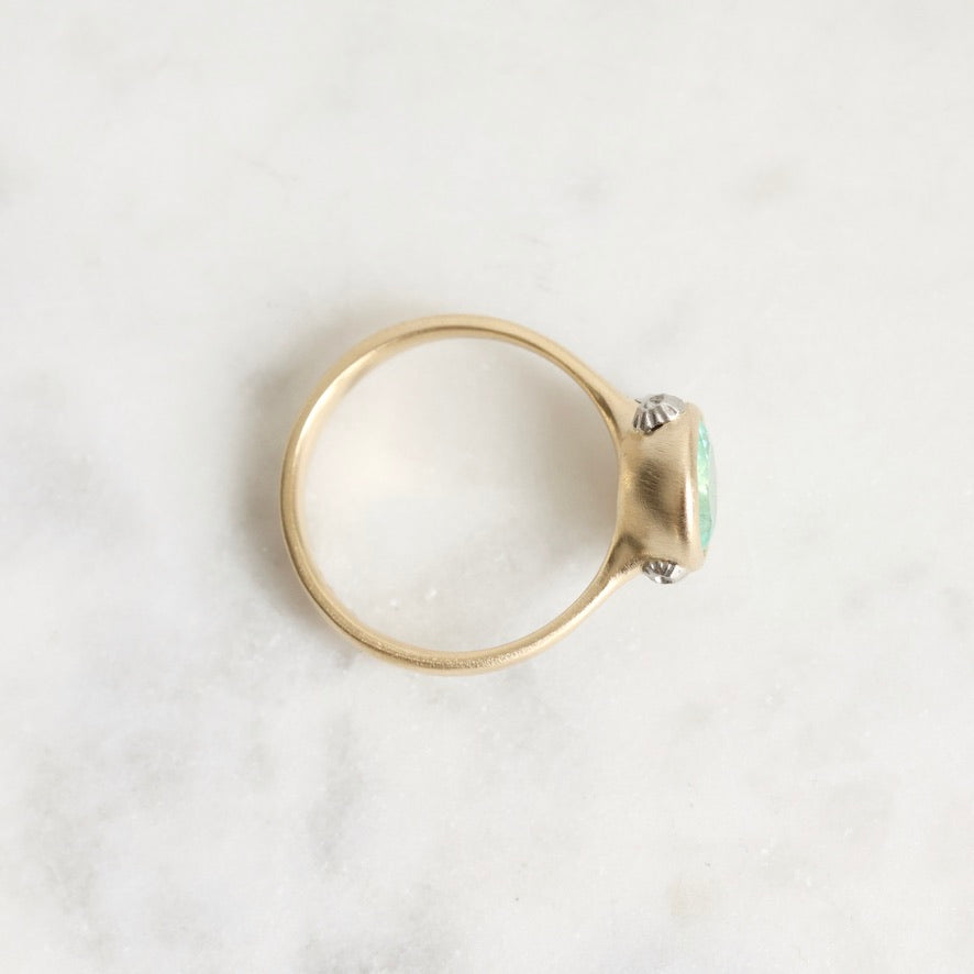 Gold ring with a gemstone on a white background
