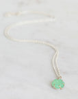 Necklace with a green pendant on a white background