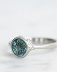 Silver ring with a blue gemstone on a white background
