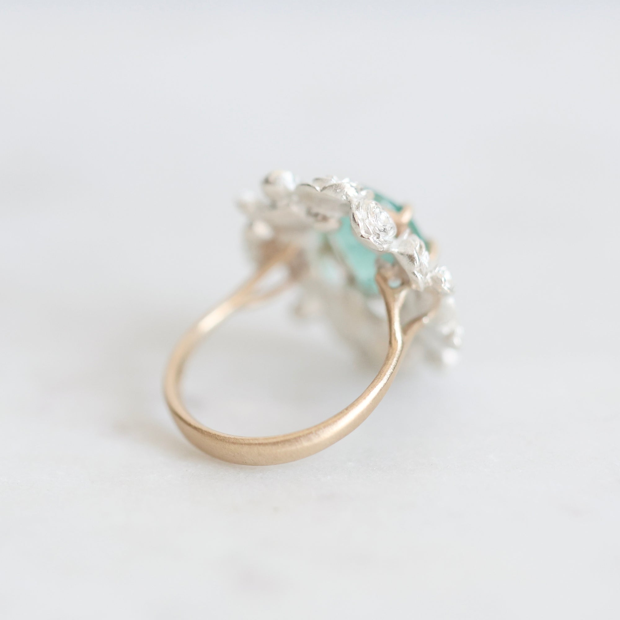 Back of wreath ring with gold band branching into setting