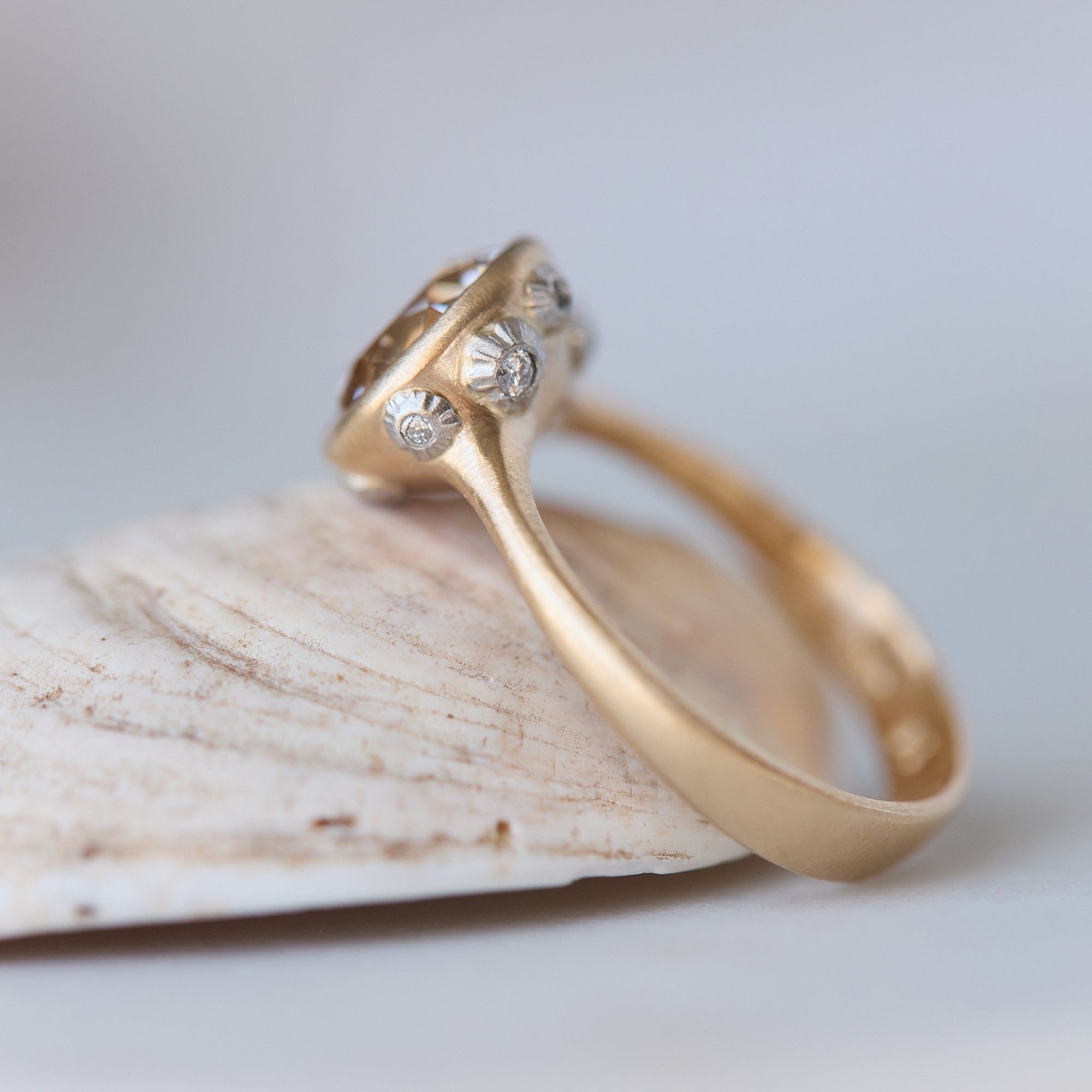 Gold ring with diamonds on a light background