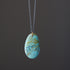 Necklace with a turquoise pendant on a dark background