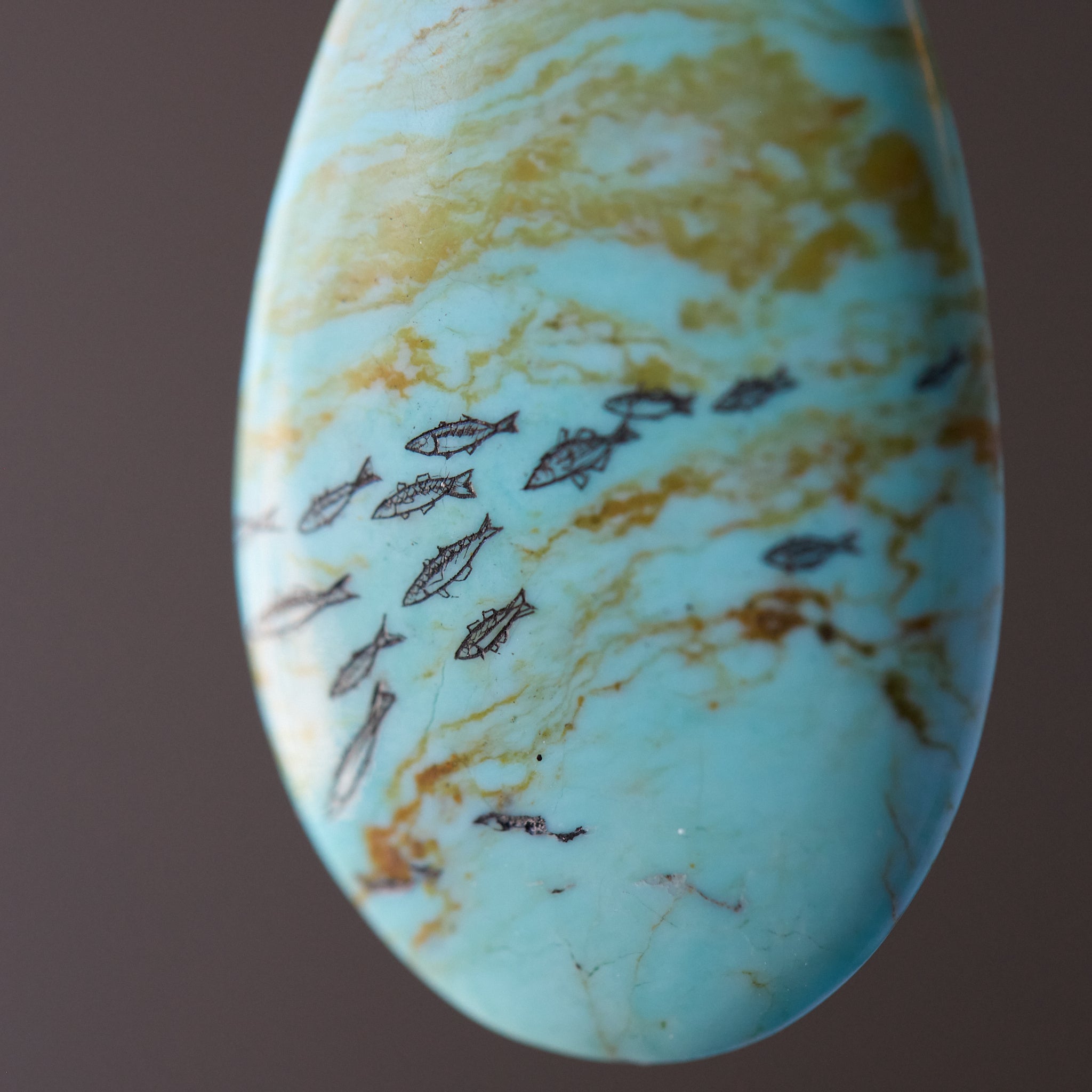 Marbled stone with turquoise and gold colors on a brown background