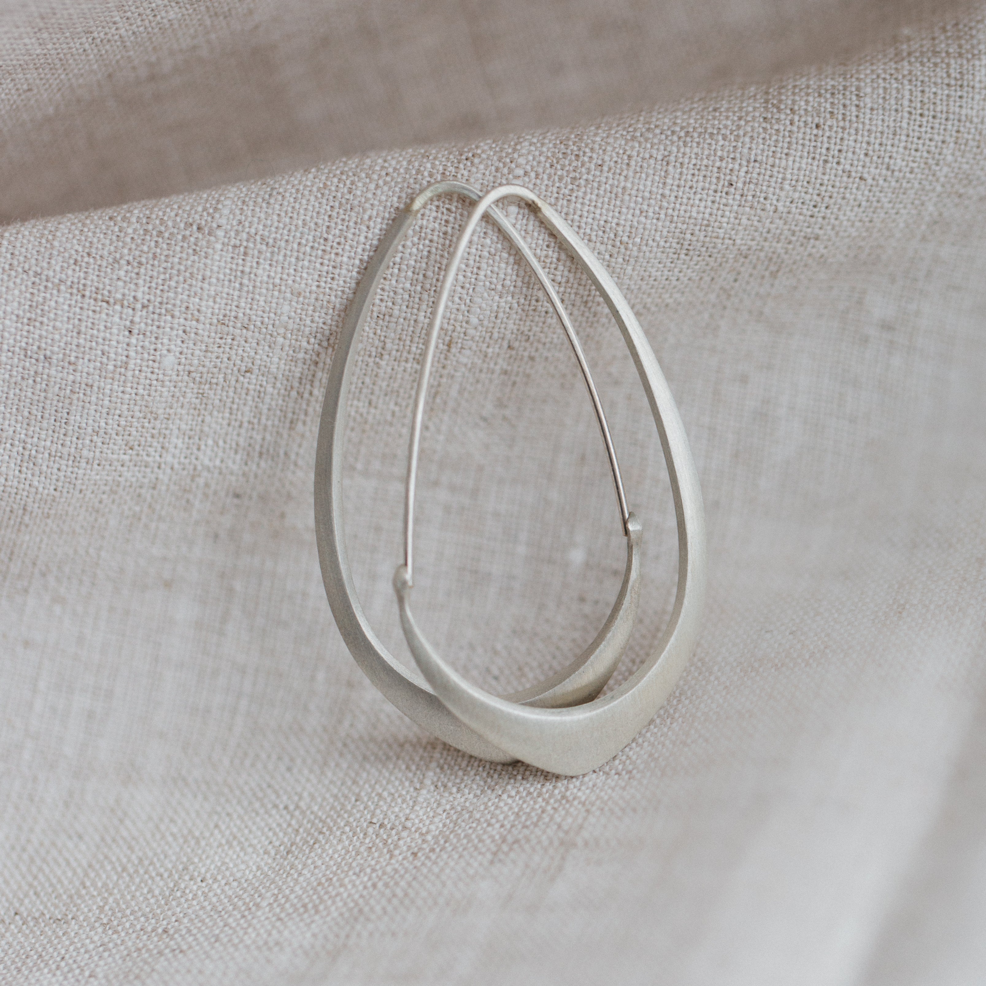 Bright silver facet hoop by Hannah Blount
