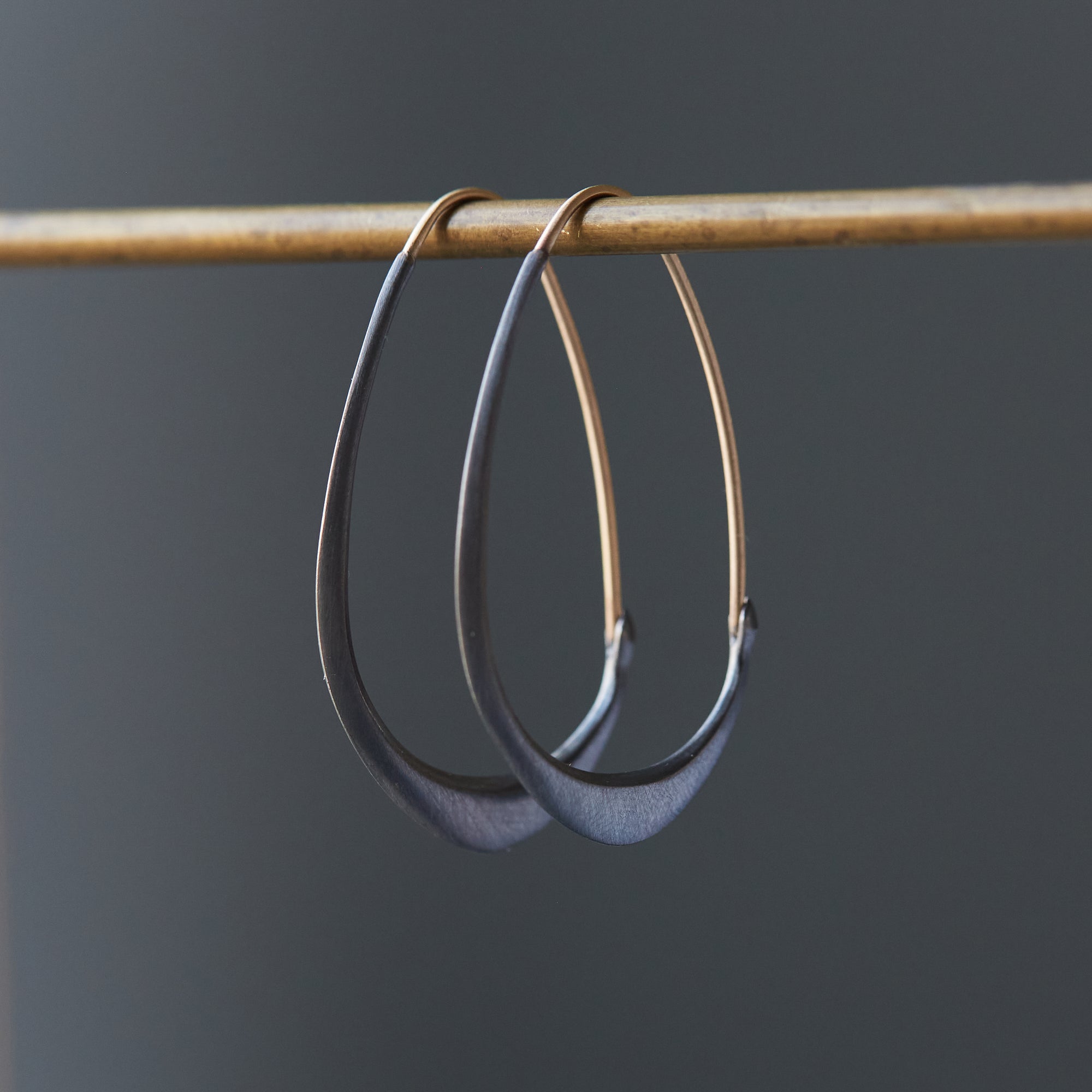 blackened silver hoops with gold ear wires