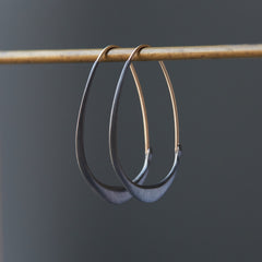 blackened silver hoops with gold ear wires