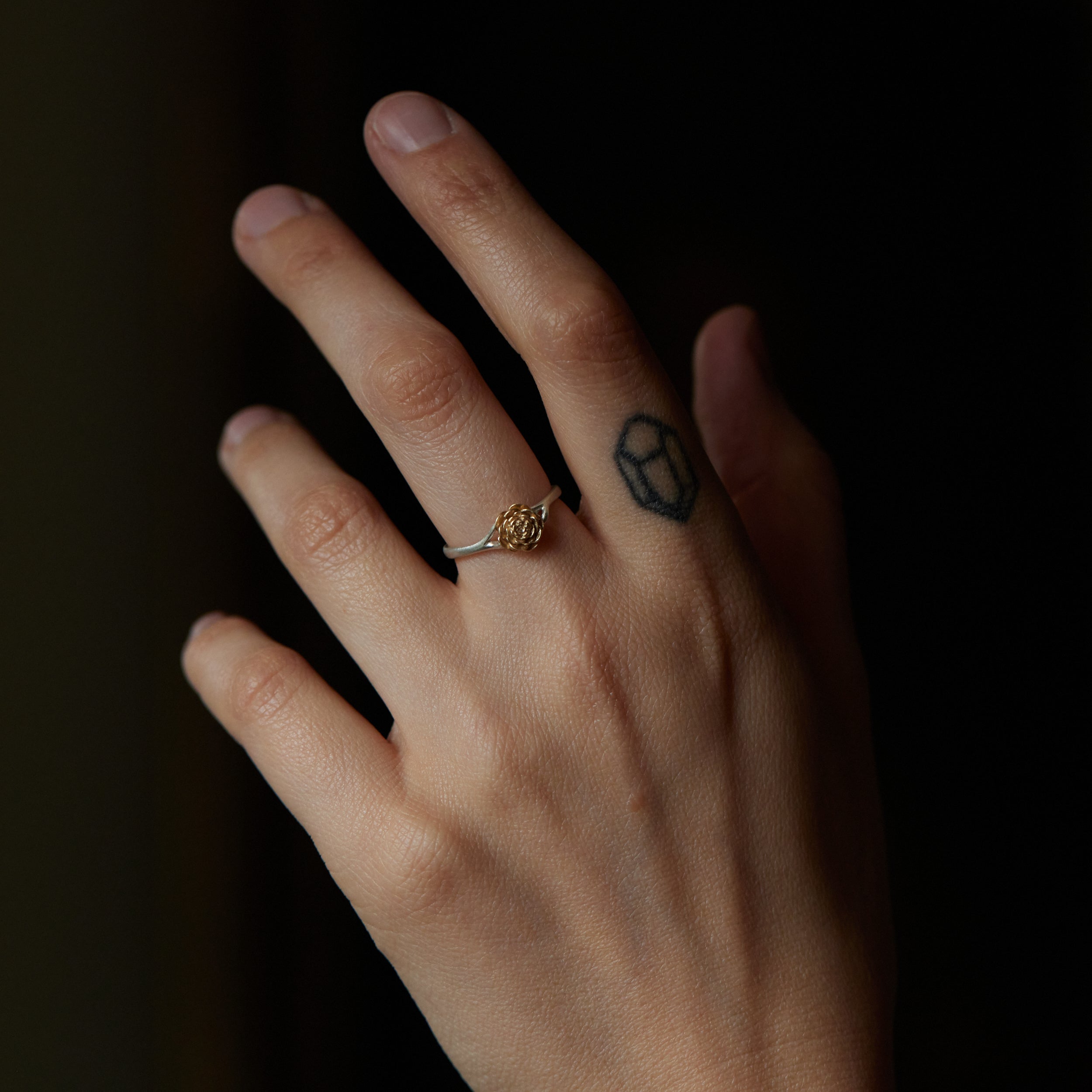 large gold and silver rose ring, shown on hand