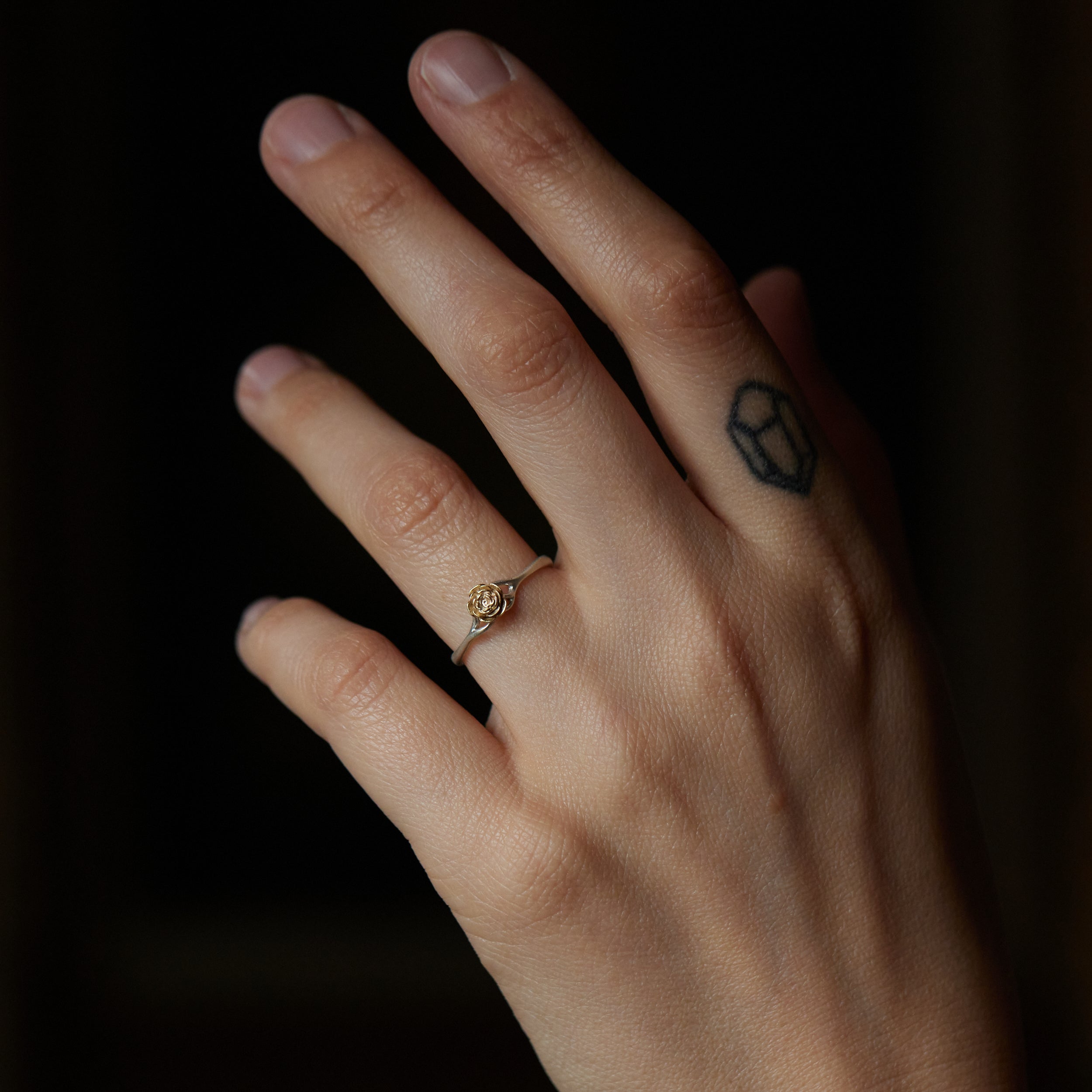 little gold and silver rose ring, shown on hand