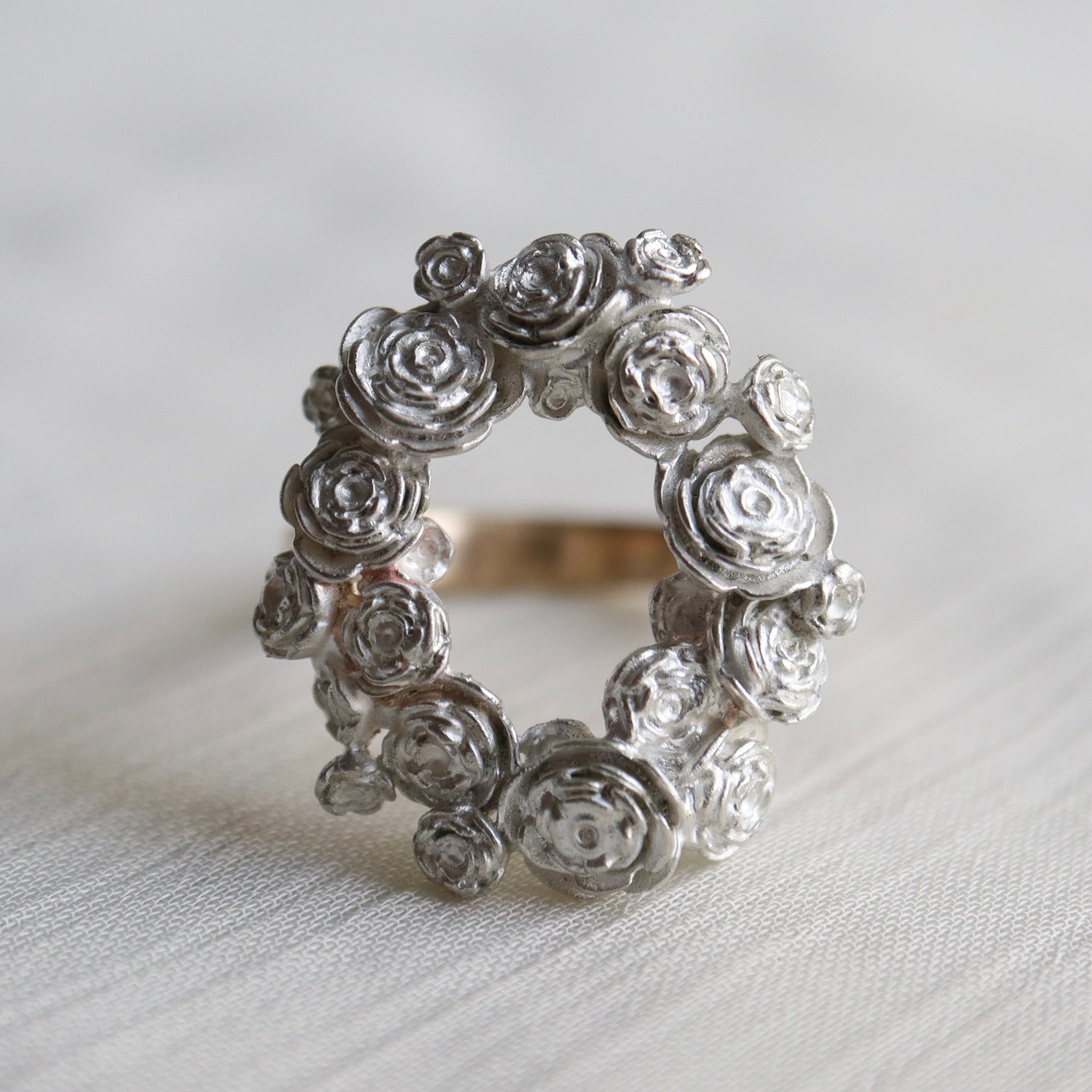 wreath of silver flowers with gold band
