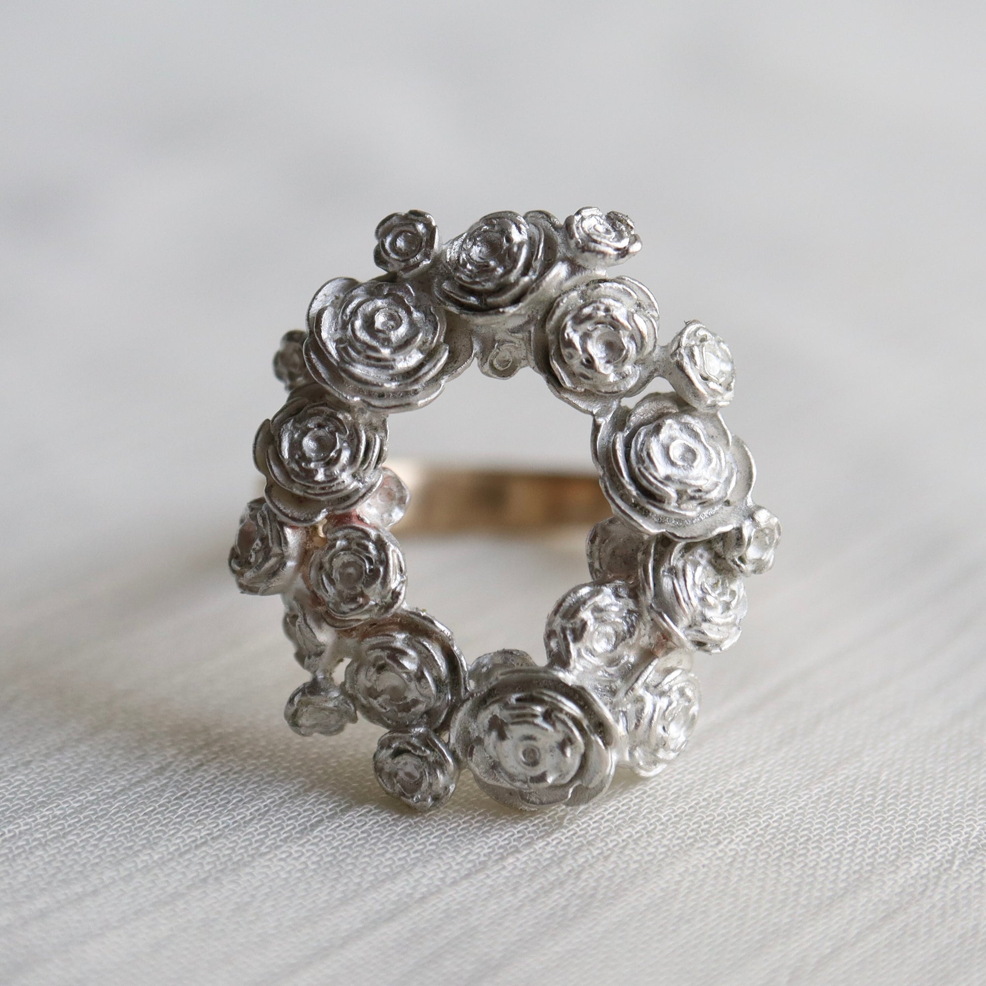 wreath of silver flowers with gold band