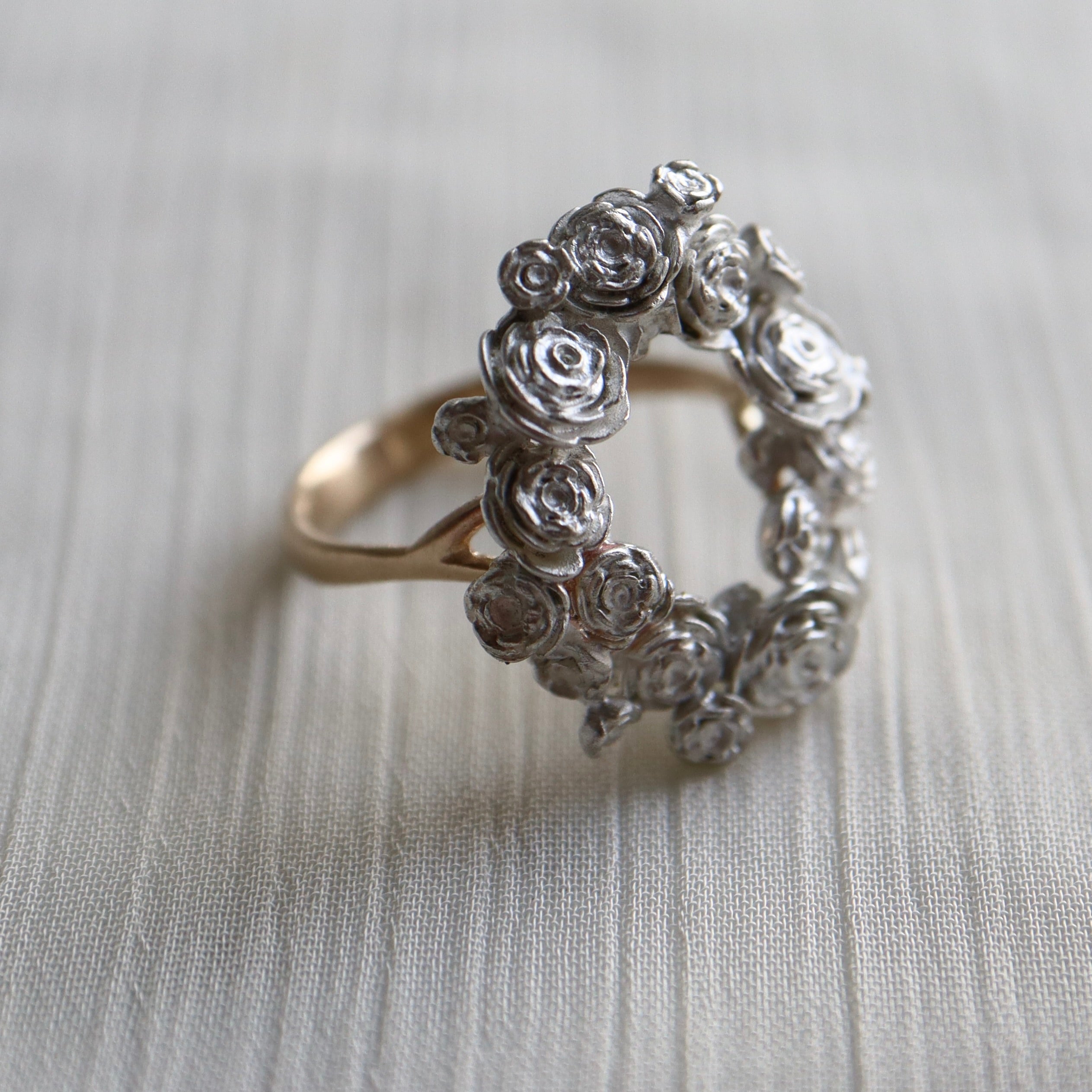 wreath of silver flowers with gold band- 1/4 view