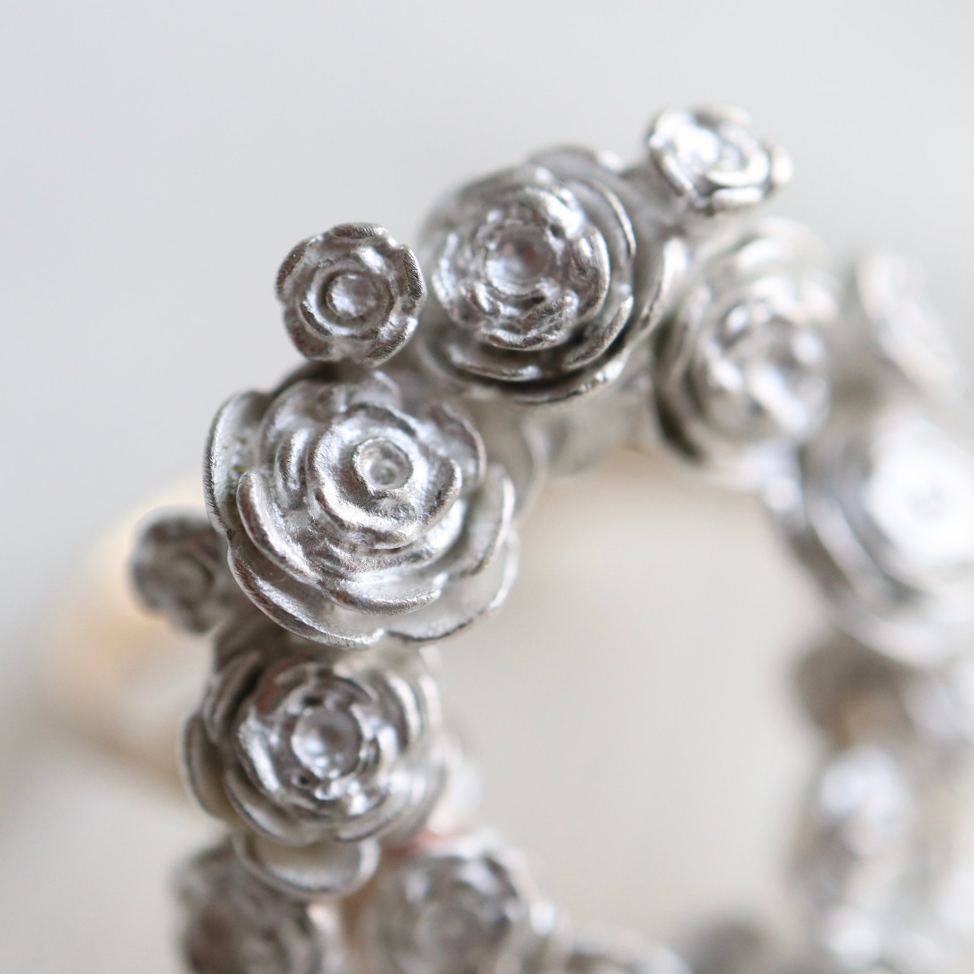 wreath of silver flowers with gold band- closeup