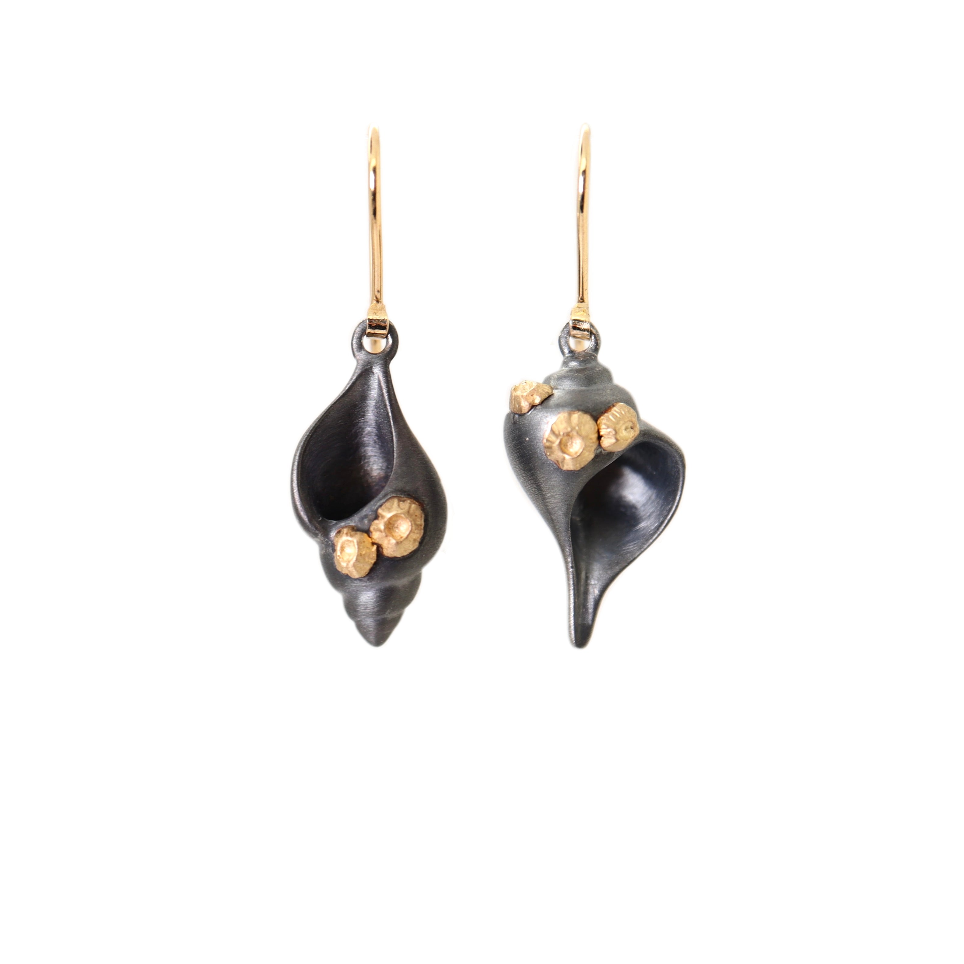 tulip and whelk spiral shells in black silver are adorned with gold barnacles and gold ear wires in handmade earrings