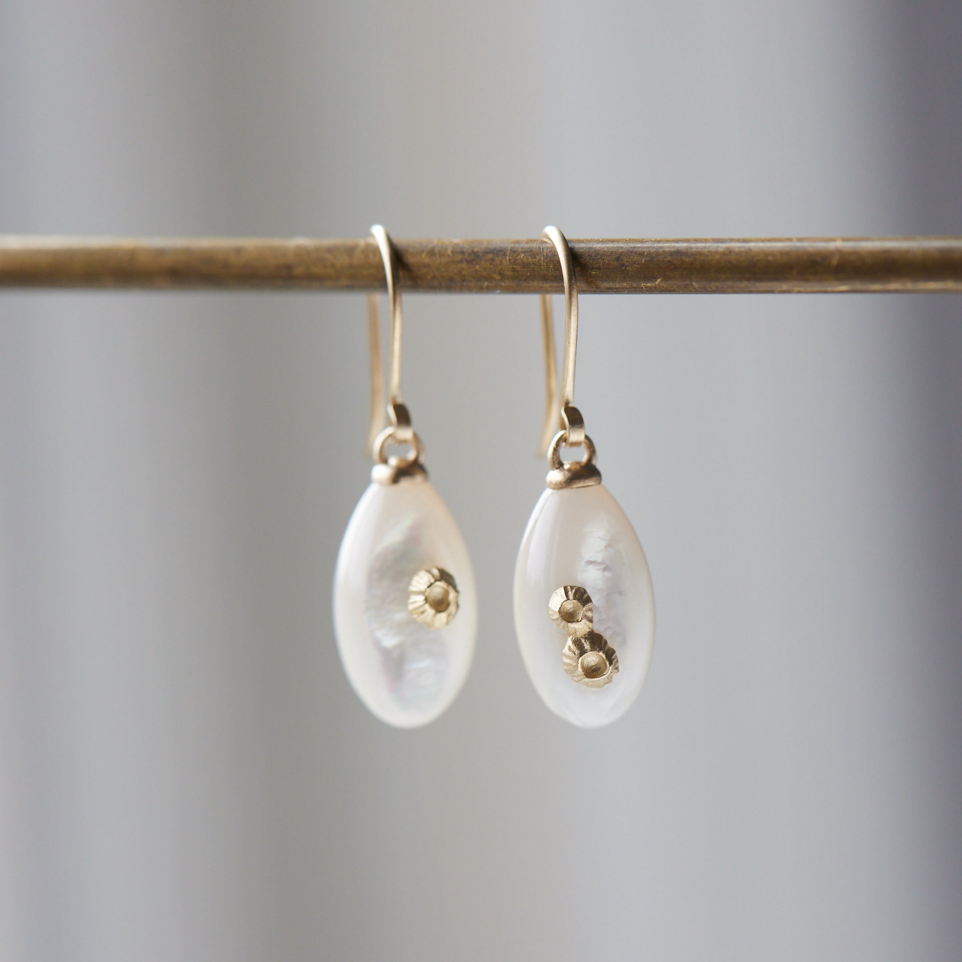 small sized mother of pearl drop earrings with gold barnacles