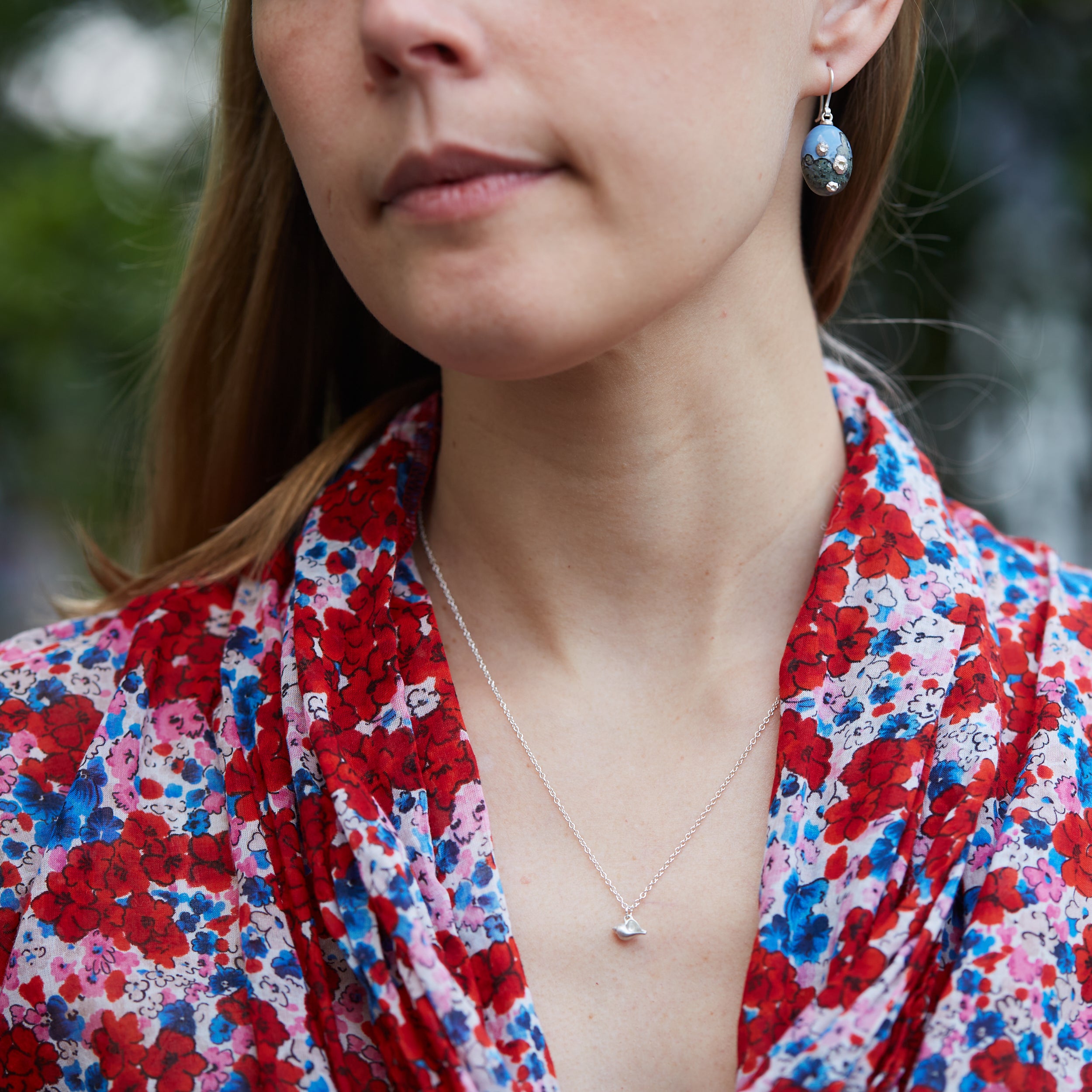 Tiny handcarved silver whelk shell by Hannah Blount, on person
