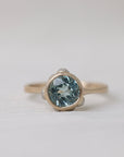 gold ring with light blue stone on white background