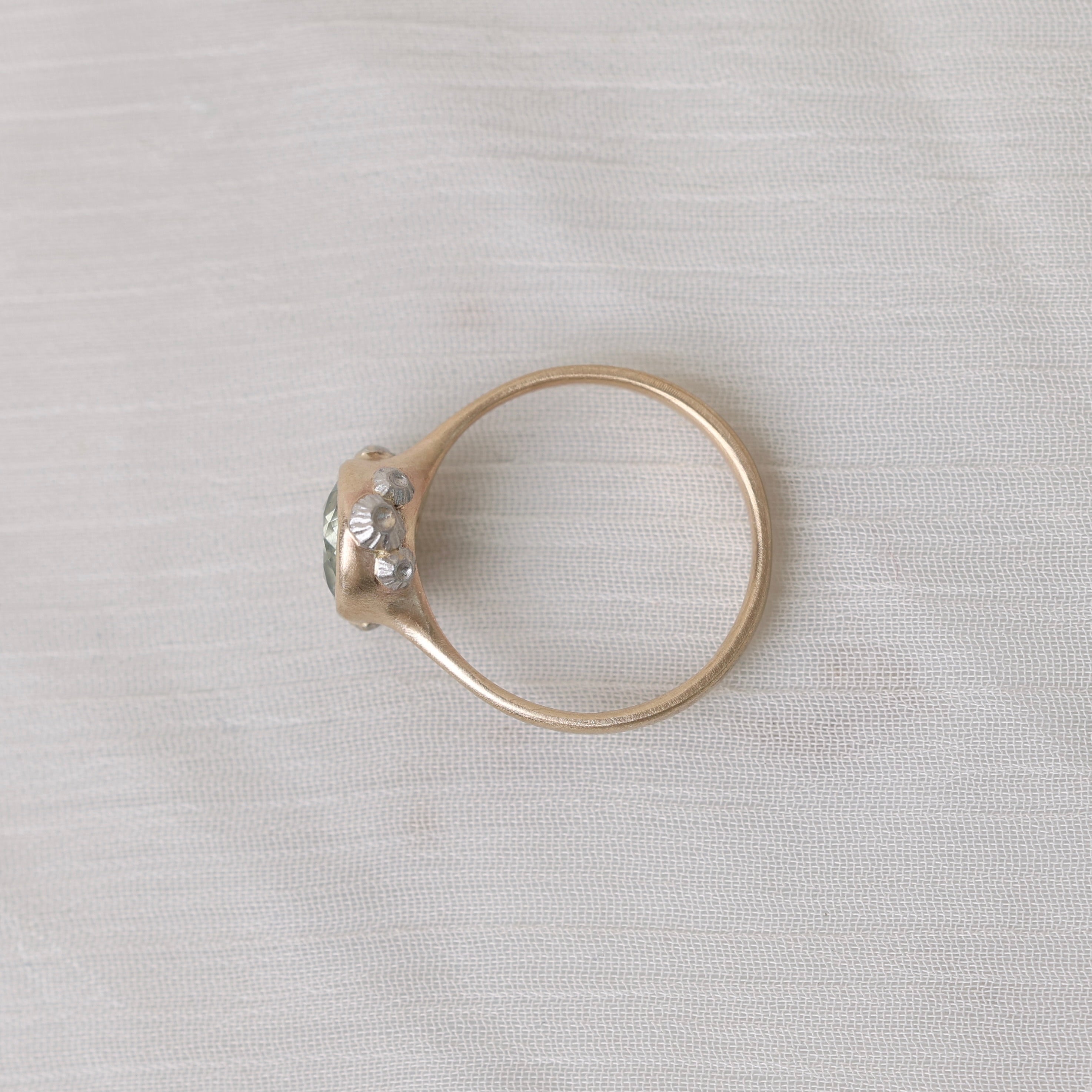 Gold ring with silver barnacles on white background