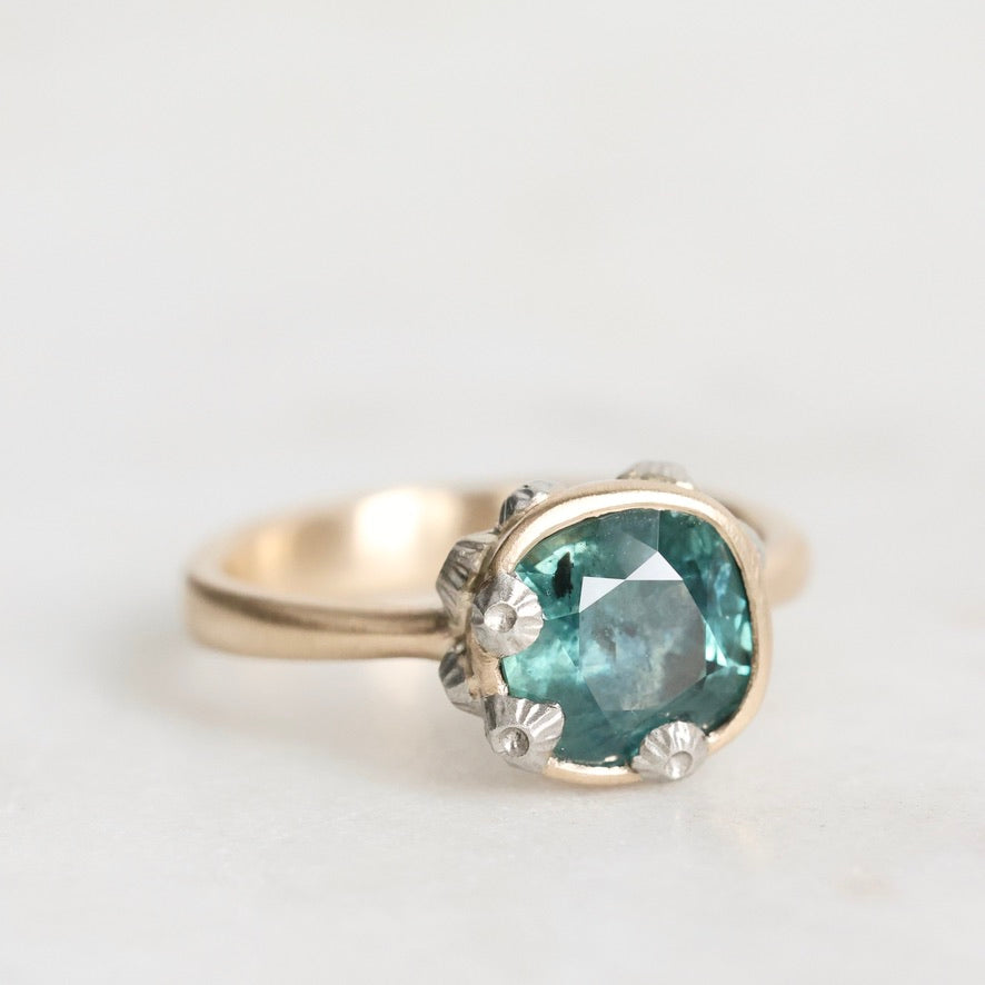 Ring with a green gemstone on a white background