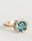 Ring with a green gemstone on a white background