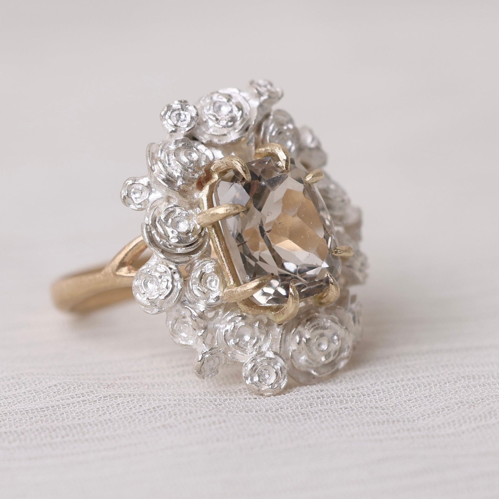 Gold  ring on a light gray background