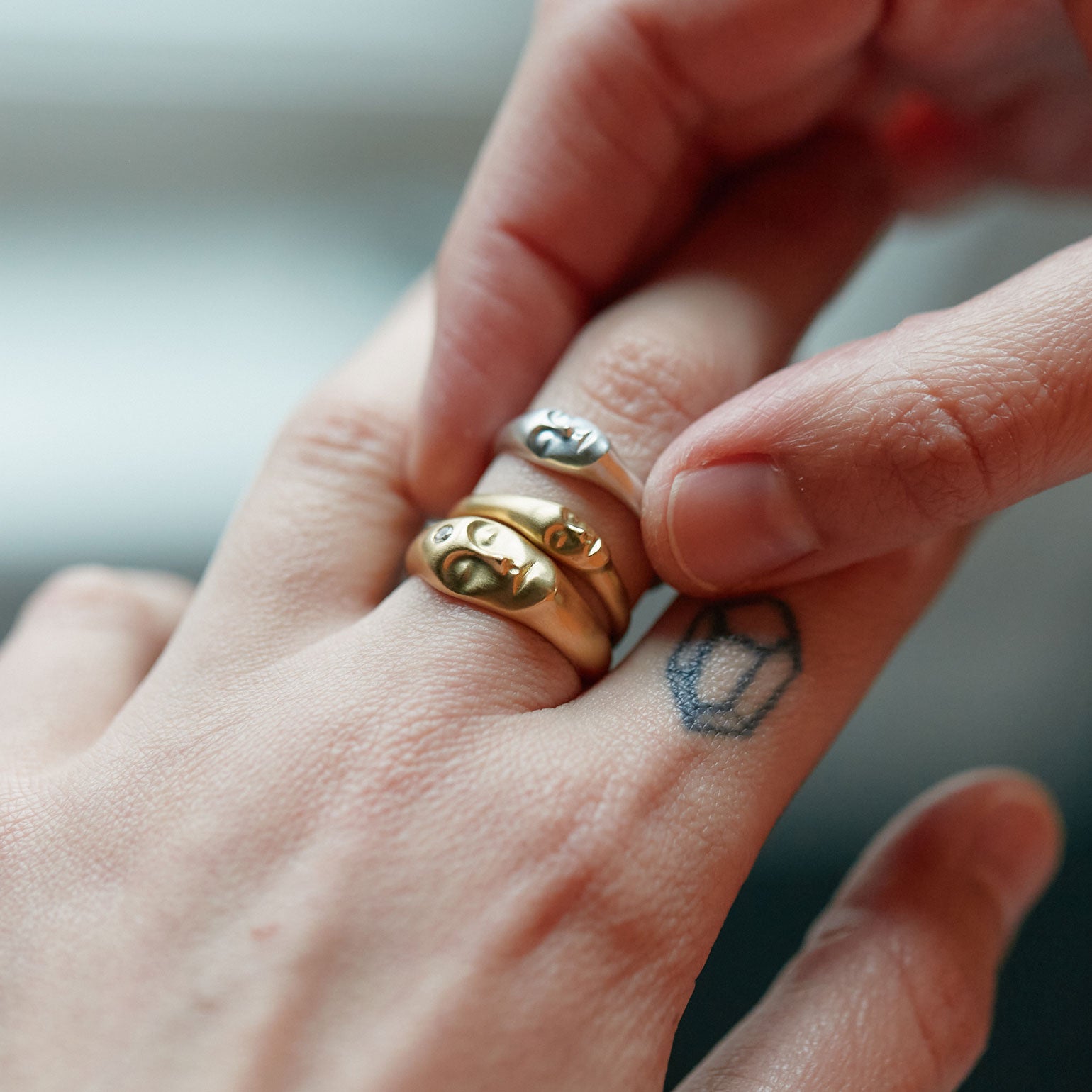 Trio of stacking cameo face rings in gold and silver