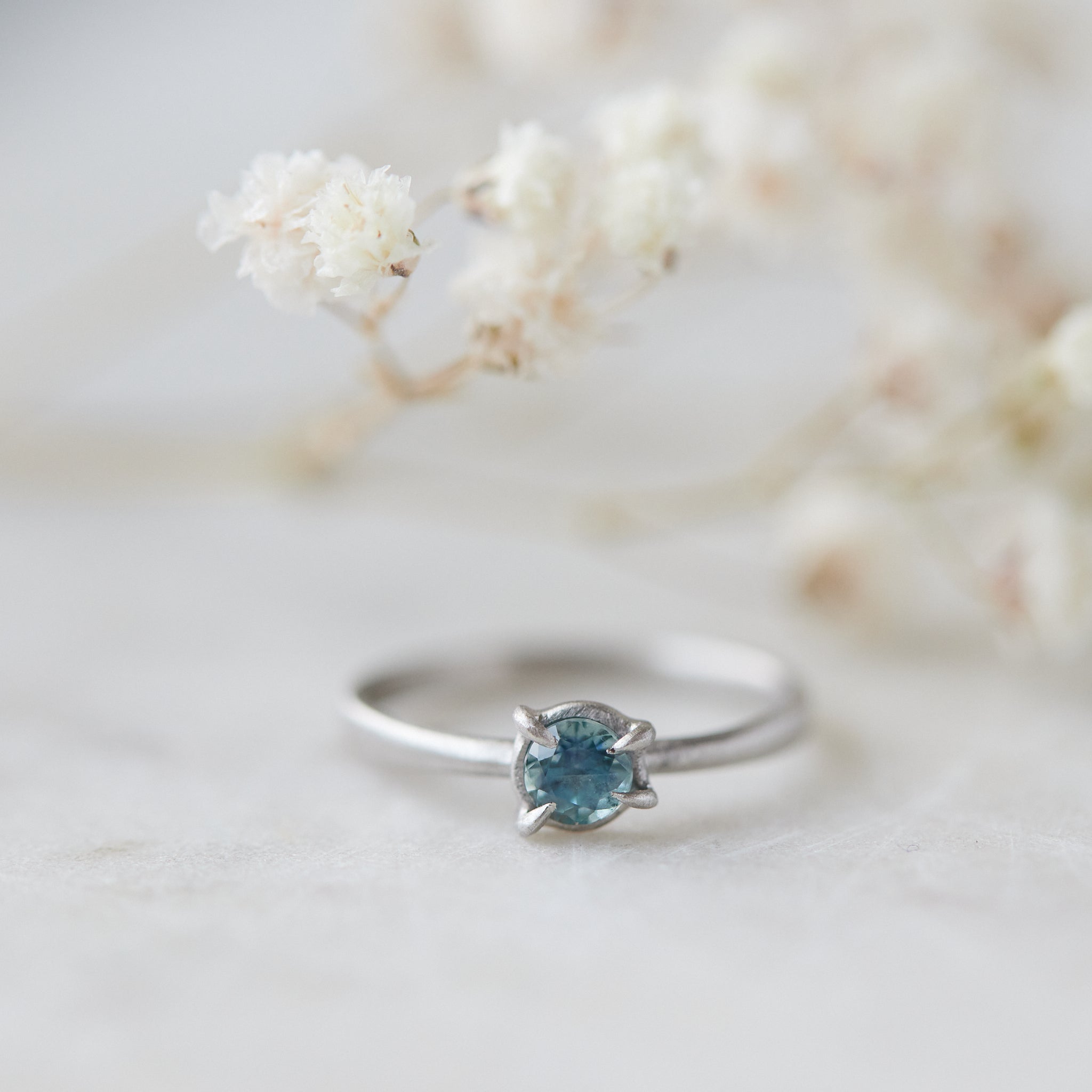 blue montana sapphire stone set in a ring of platinum via prongs