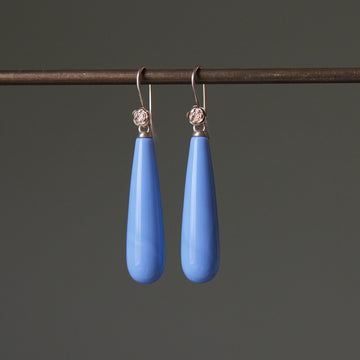 long teardrops of blue common opal hang beneath gold ear wires and roses