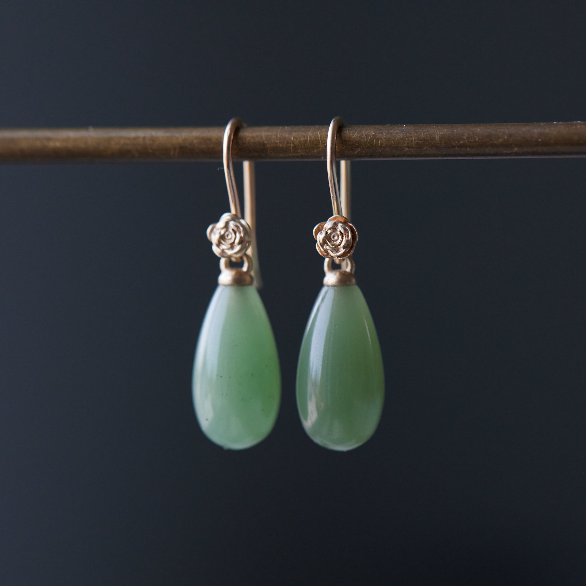sage green nephrite jade teardrops hang beneath gold rose ear wires