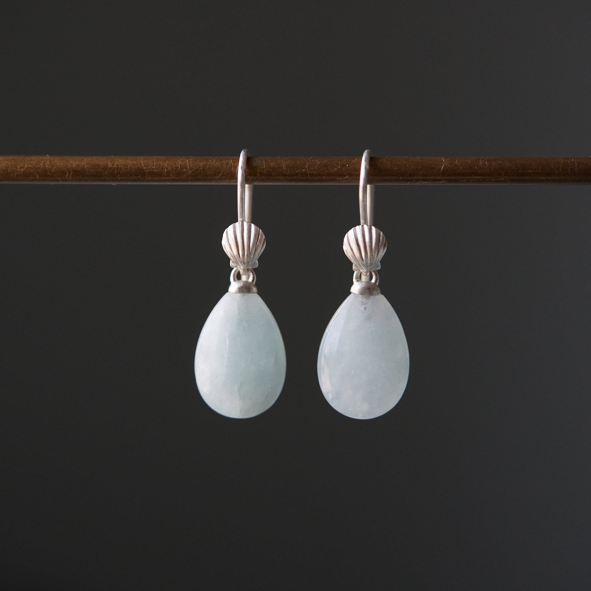 teardrops of pale, icy aquamarine hang beneath little silver scallop shell ear wires