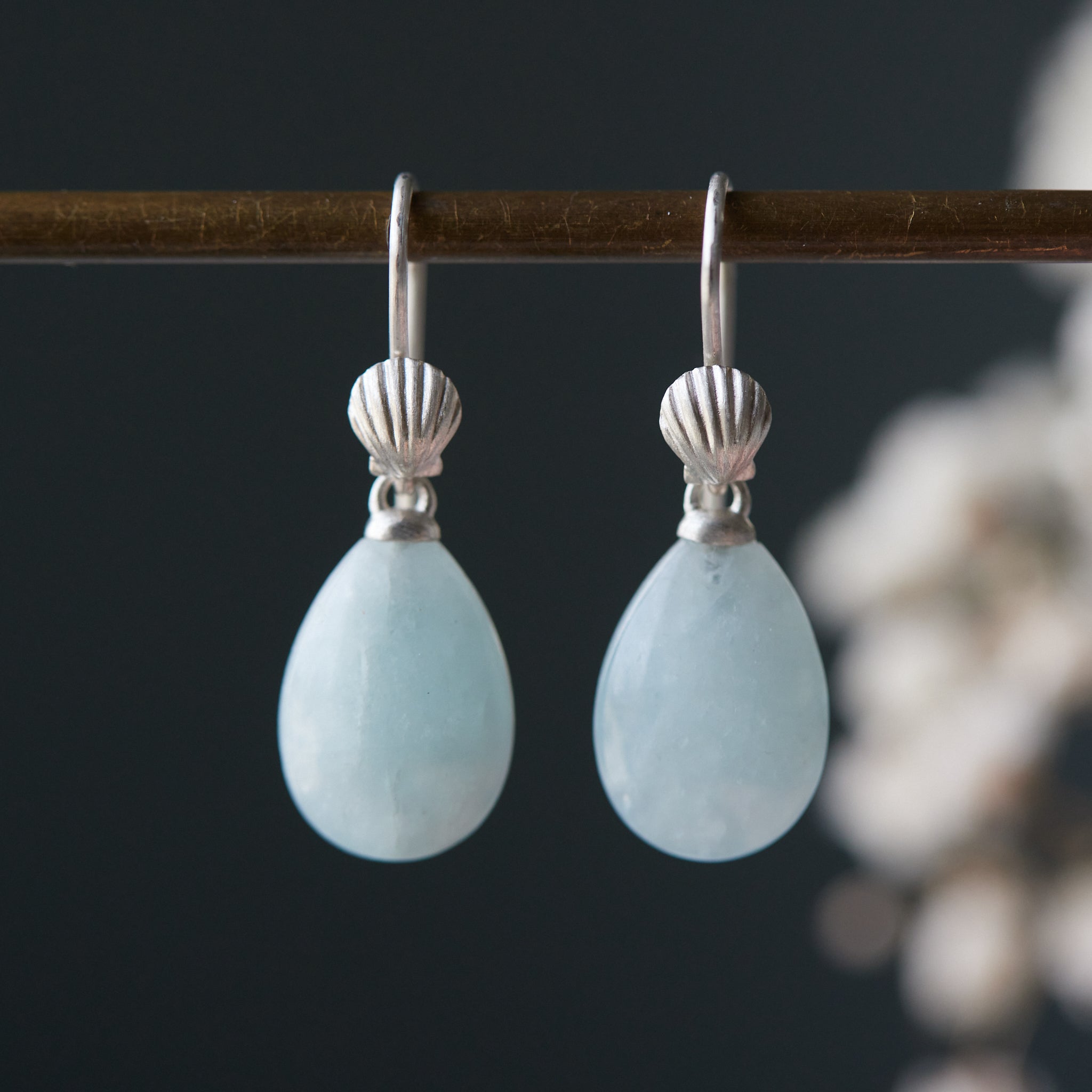 teardrops of pale, icy aquamarine hang beneath little silver scallop shell ear wires