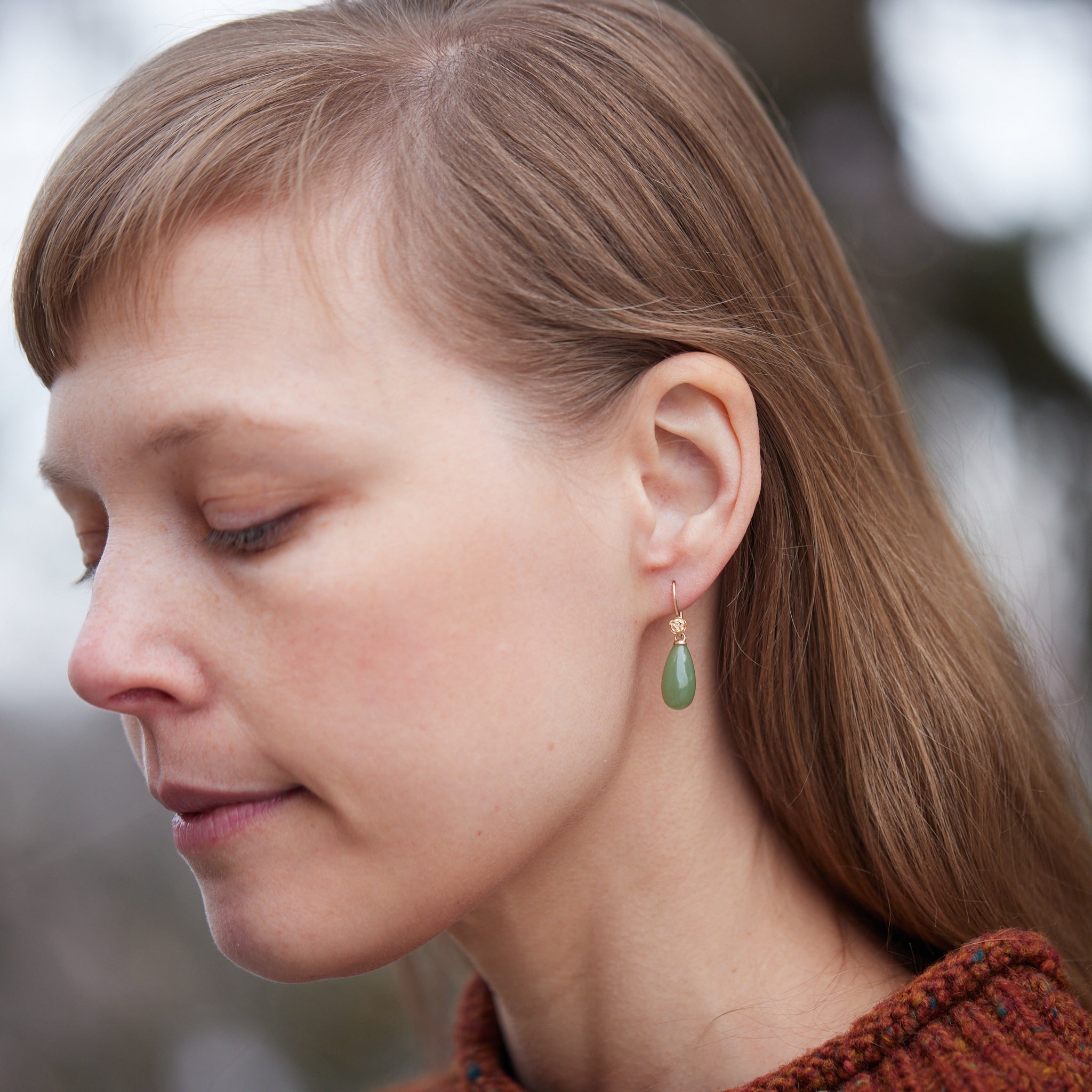 sage green nephrite jade teardrops hang beneath gold rose ear wires