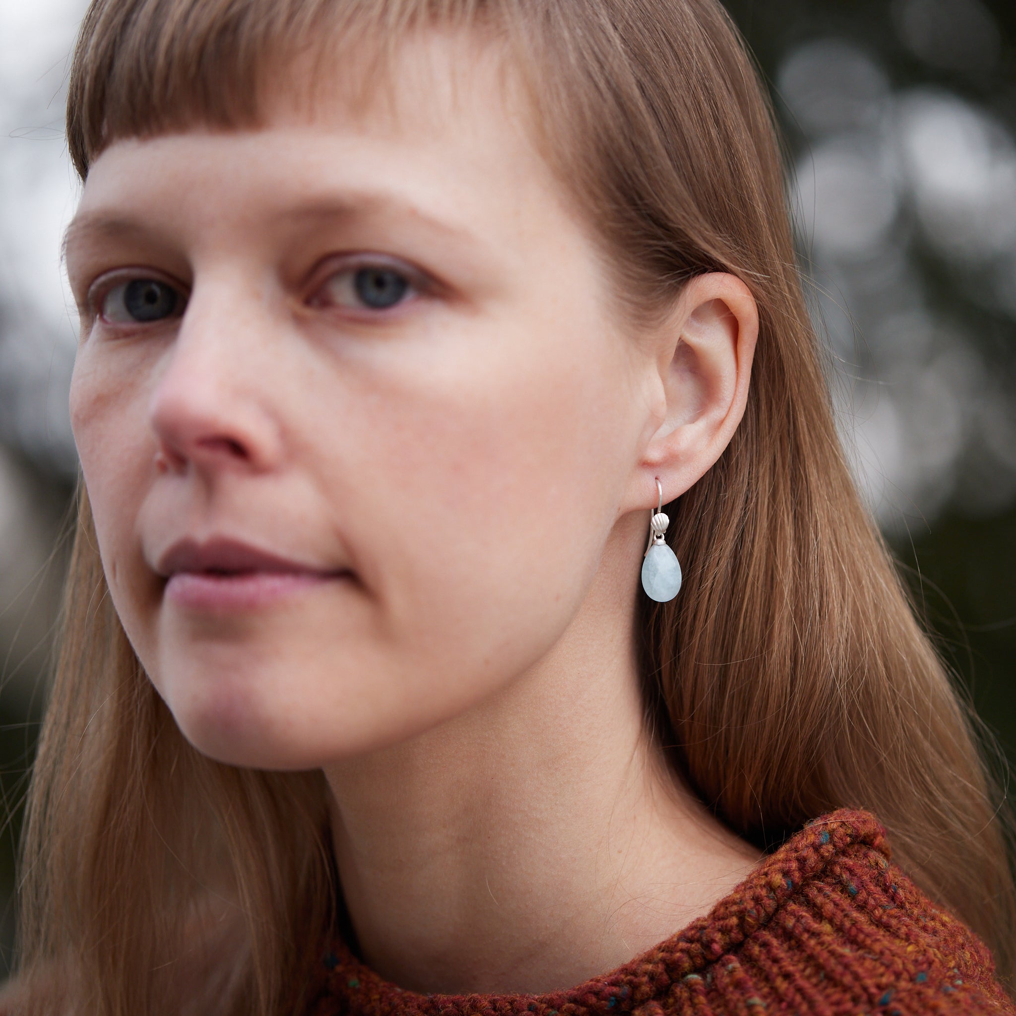 teardrops of pale, icy aquamarine hang beneath little silver scallop shell ear wires