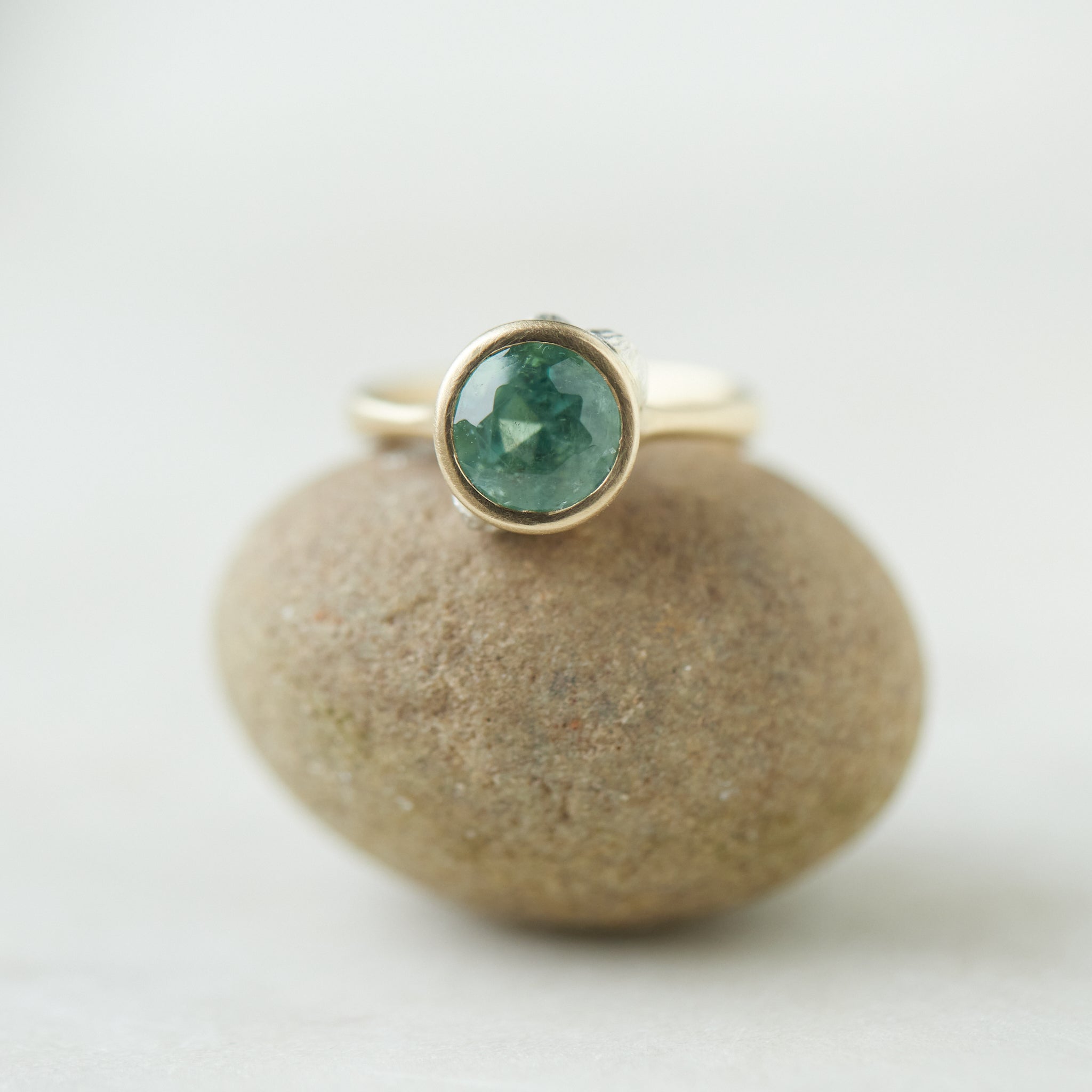 Tourmaline in yellow gold bezel setting with hand-carved barnacles