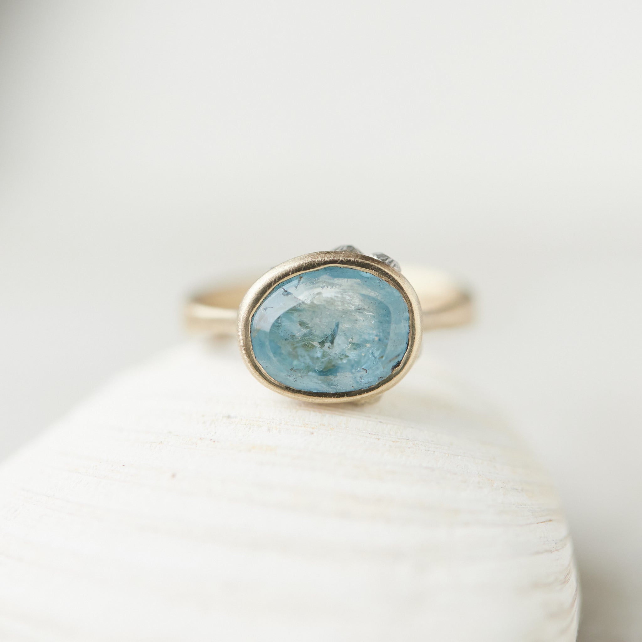 Aquamarine gold bezel ring with hand-carved barnacles