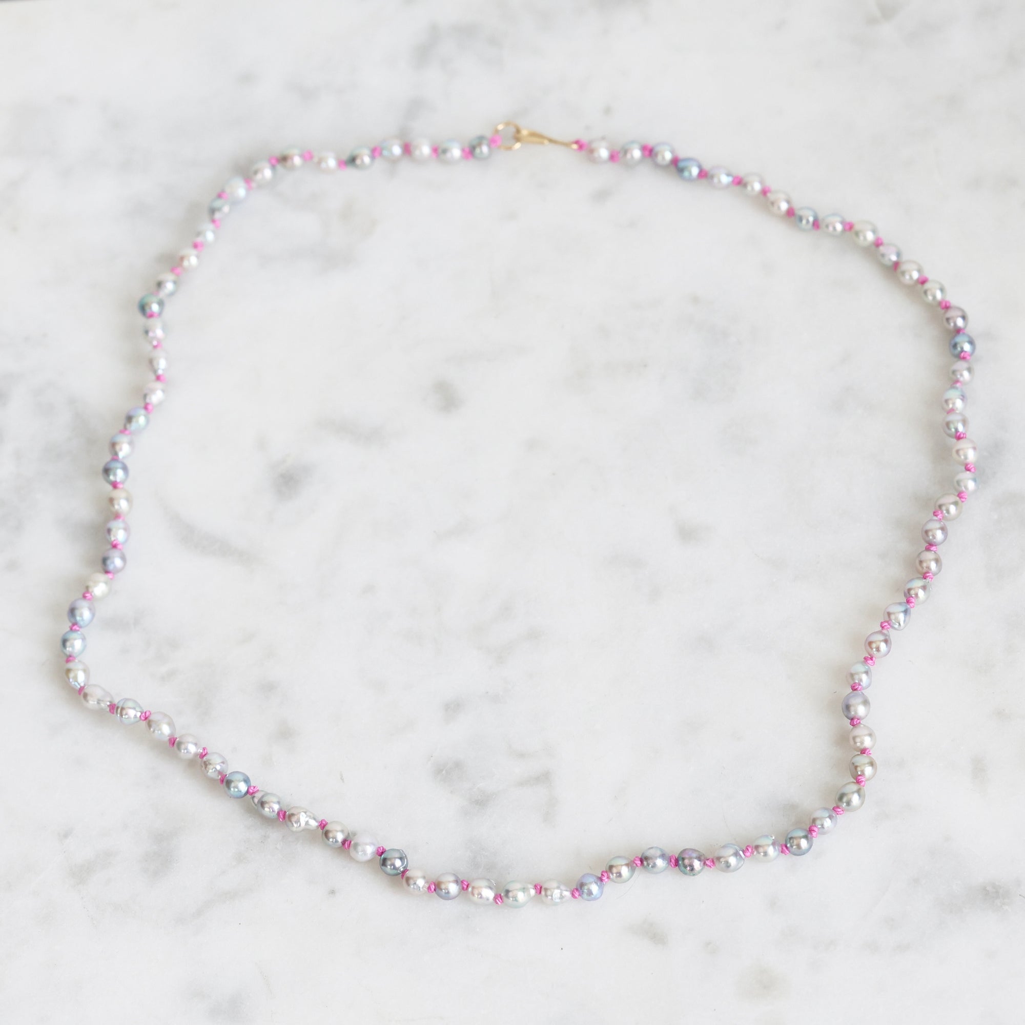 Multicolored beaded necklace on a marble surface