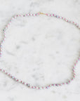 Multicolored beaded necklace on a marble surface