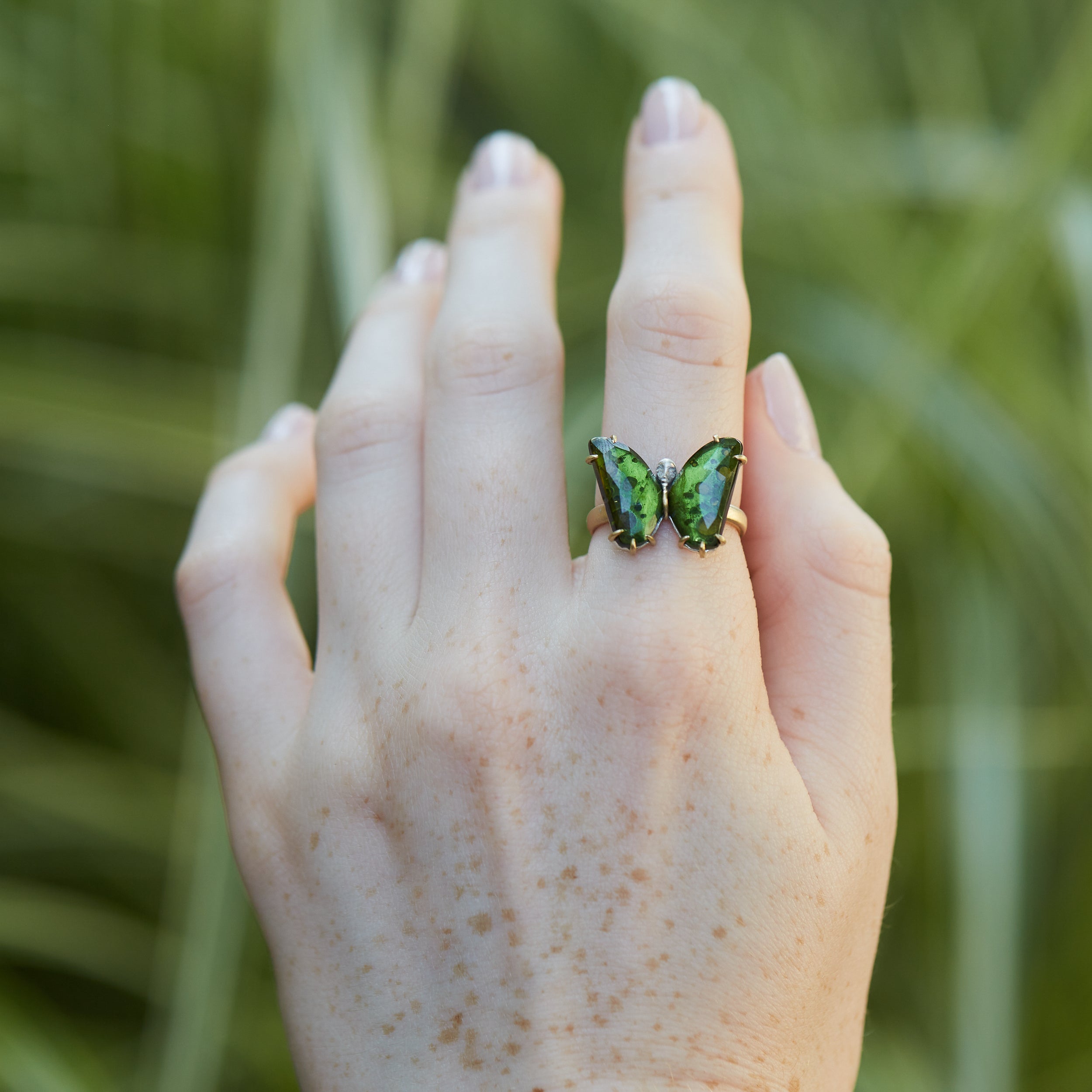 Green Tourmaline Psyche Butterfly Cameo face ring on person by hannah blount jewelry